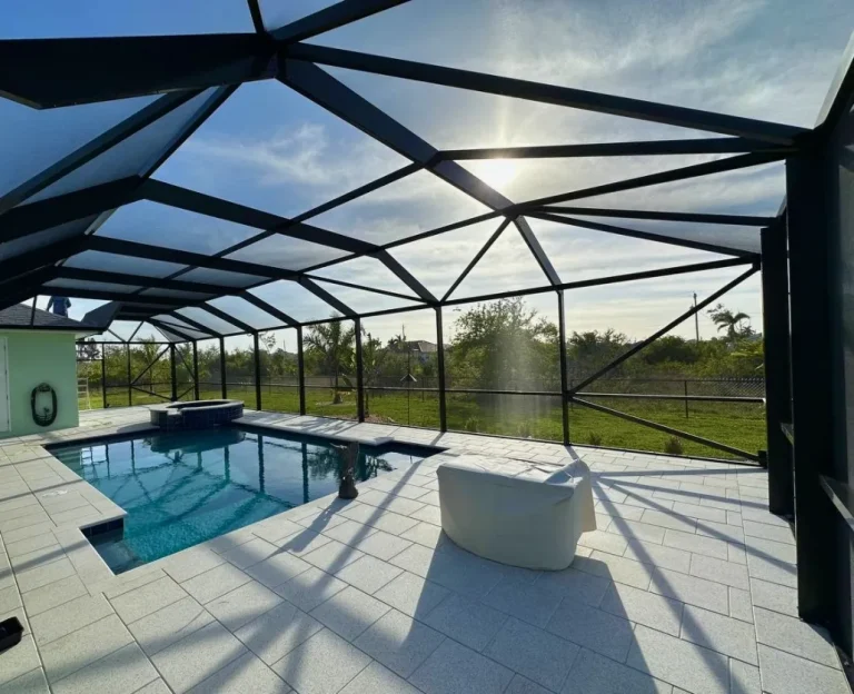 Lanai Swimming Pool vs Screen Swimming Pool Enclosures showing a modern lanai with a solid roof beside a Florida home